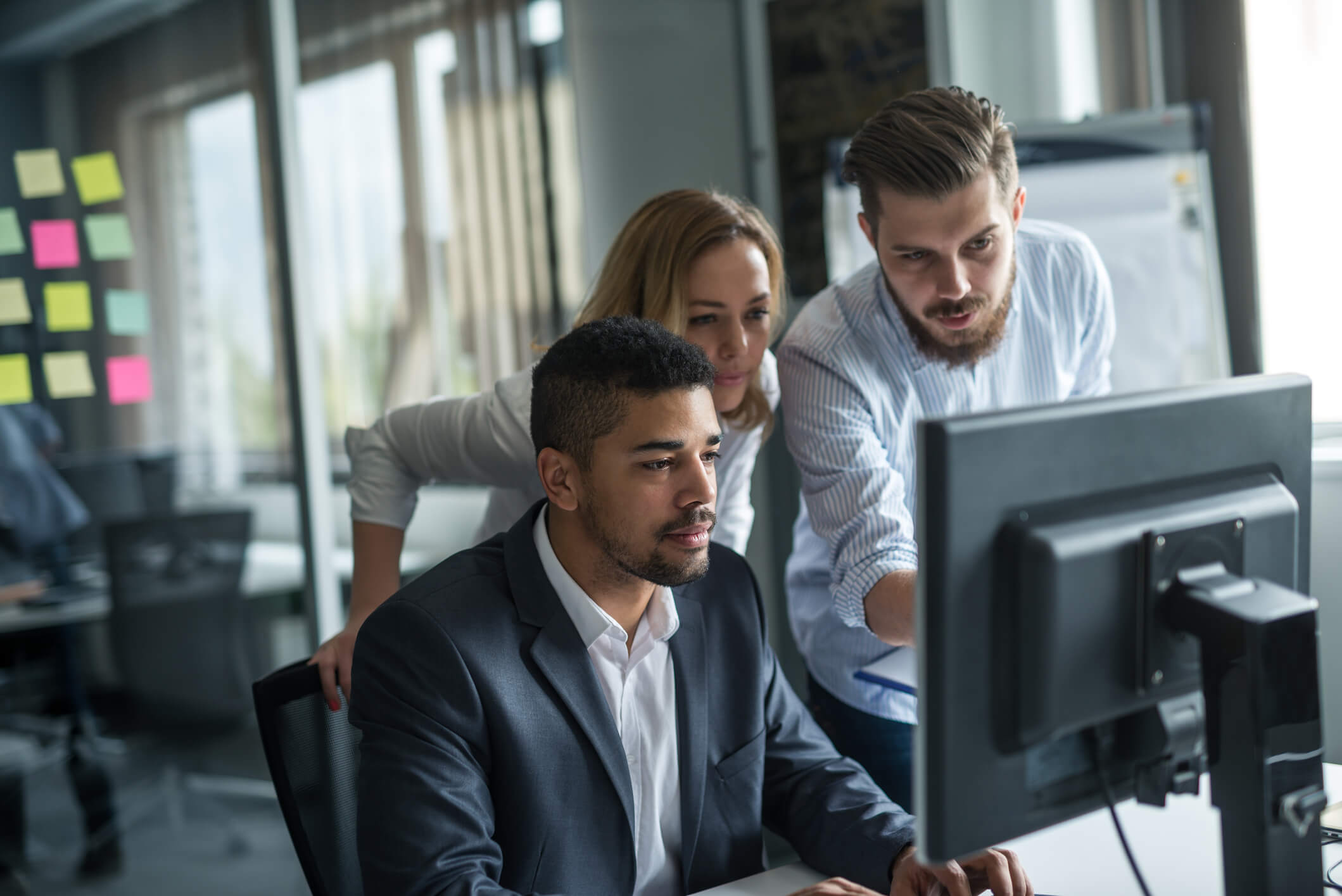 Group of people working together at a computer