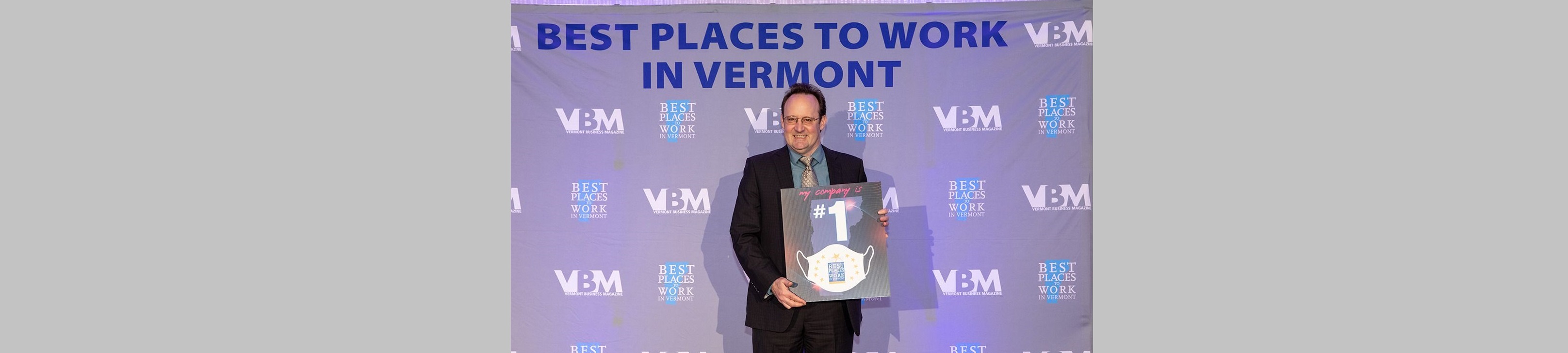 Mike Slattery holds #1 Best Place to Work in Vermont Award